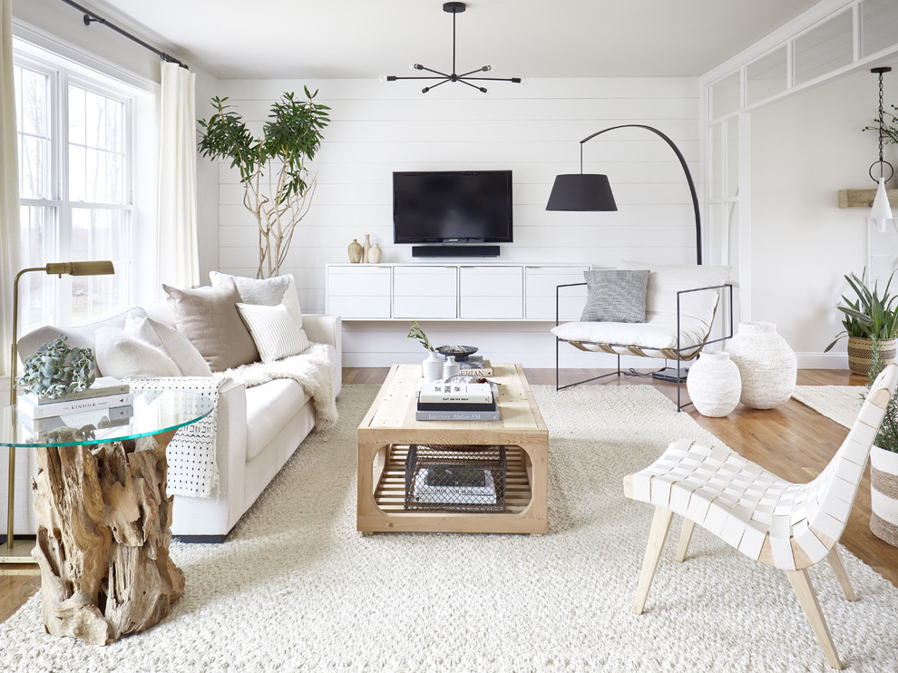 Inspiration for a small country open concept living room in Bridgeport with white walls, brown floor, medium hardwood floors, no fireplace and a wall-mounted tv.