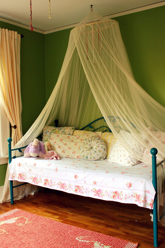 This is an example of a traditional kids' room for girls in Albuquerque with green walls.