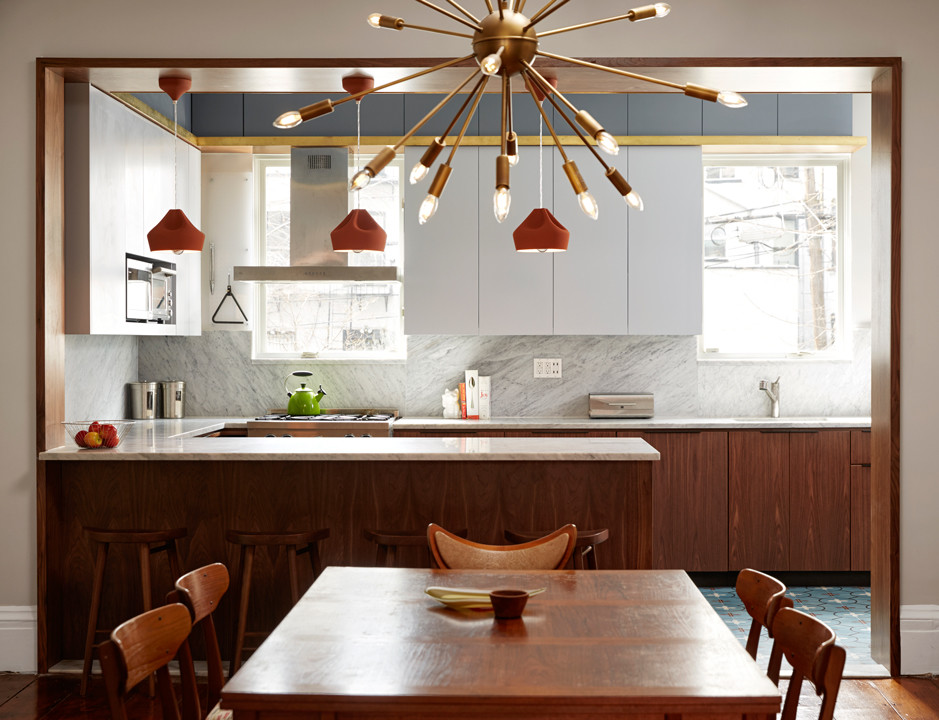 Inspiration for a contemporary kitchen in New York with marble benchtops and stone slab splashback.
