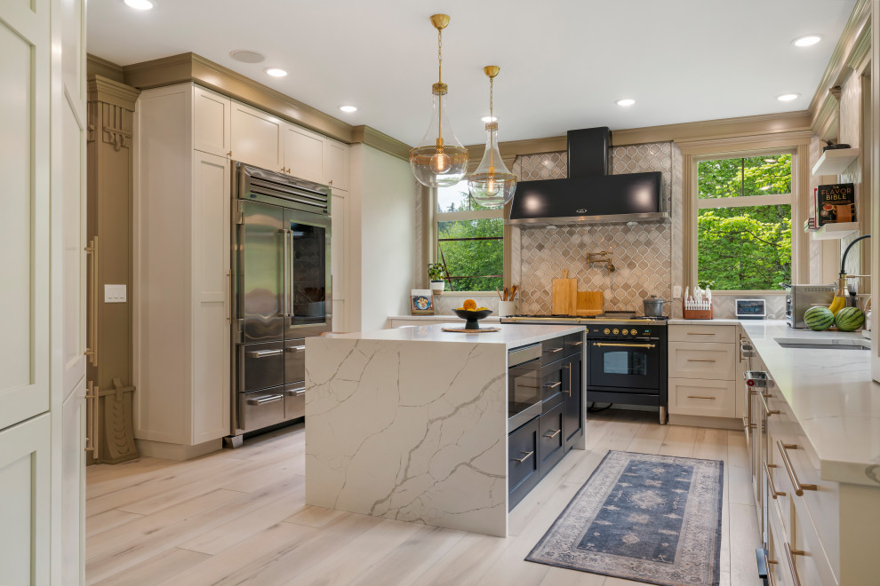 This is an example of a large traditional u-shaped separate kitchen in Seattle with a drop-in sink, beaded inset cabinets, white cabinets, marble benchtops, beige splashback, ceramic splashback, stainless steel appliances, vinyl floors, with island, beige floor and white benchtop.