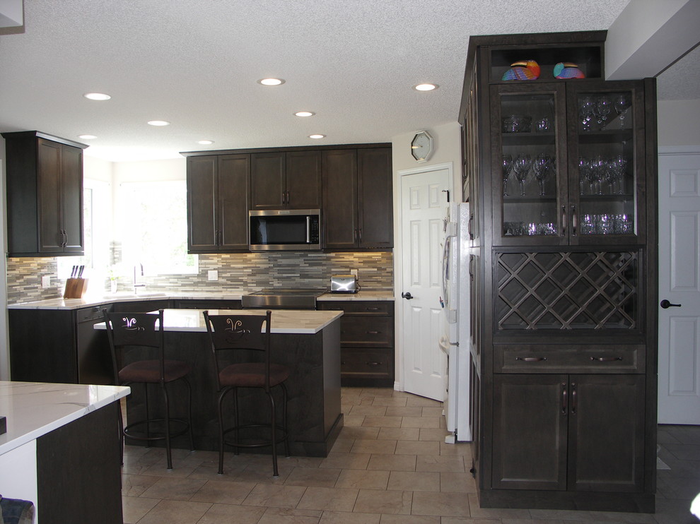 Example of a mid-sized transitional u-shaped porcelain tile open concept kitchen design in Edmonton with an undermount sink, recessed-panel cabinets, dark wood cabinets, quartzite countertops, multicolored backsplash, matchstick tile backsplash, white appliances and two islands