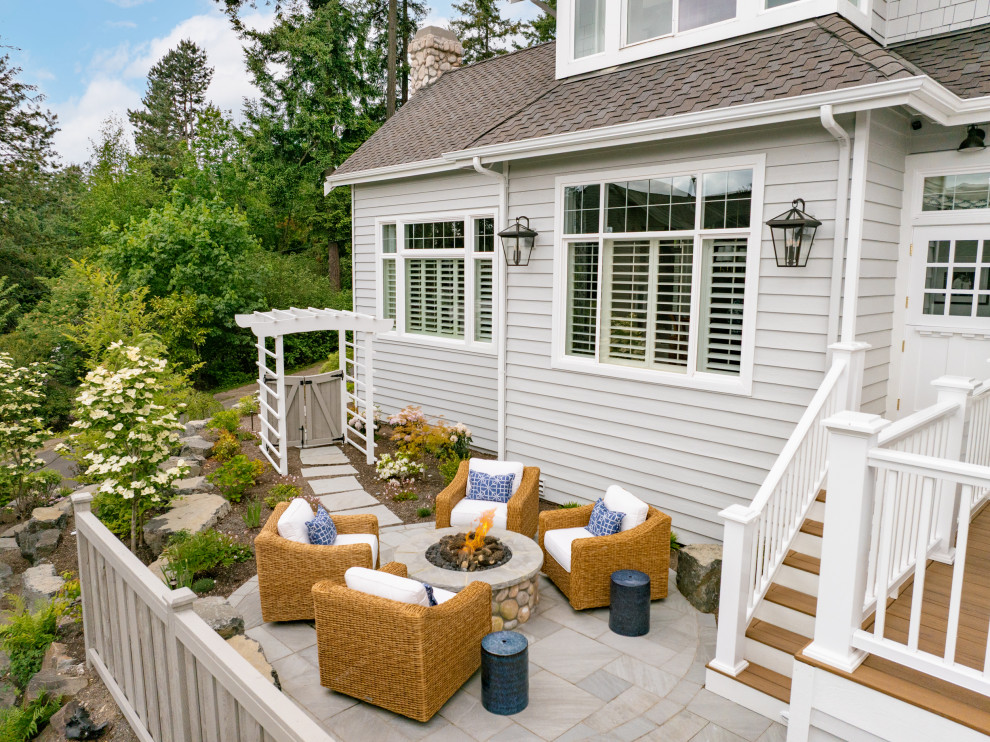 Inspiration for a large coastal gray two-story wood and shingle house exterior remodel in Seattle with a shingle roof and a brown roof