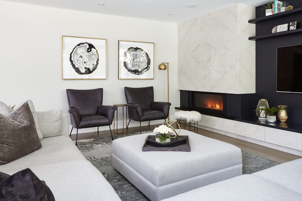 Inspiration for a contemporary living room in Toronto with light hardwood floors, a ribbon fireplace, a wall-mounted tv, brown floor and white walls.