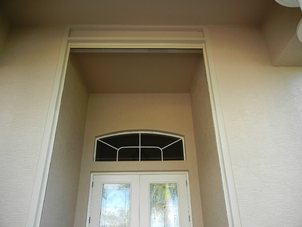 Inspiration for a single front door remodel in Miami with a brown front door