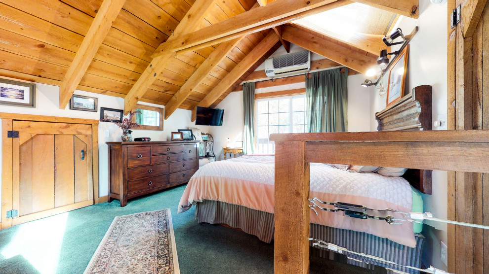 Photo of a mid-sized country loft-style bedroom in New York with carpet and turquoise floor.