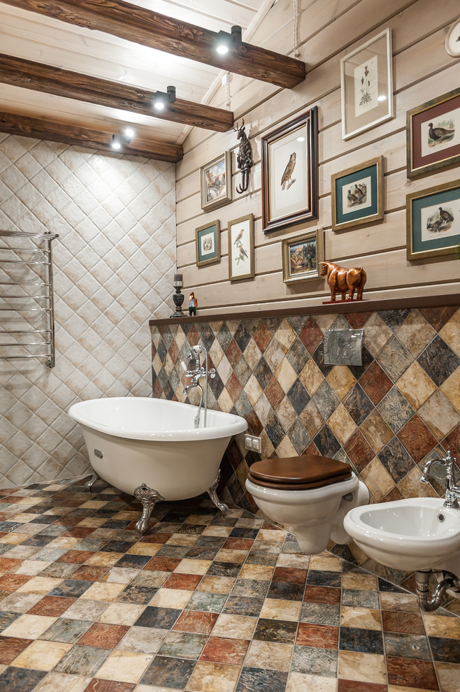 Photo of a mid-sized country master wet room bathroom in Other with a claw-foot tub, a wall-mount toilet, multi-coloured tile, multi-coloured walls, ceramic floors, an integrated sink, solid surface benchtops, multi-coloured floor, a sliding shower screen, beige benchtops, porcelain tile, exposed beam and wood walls.