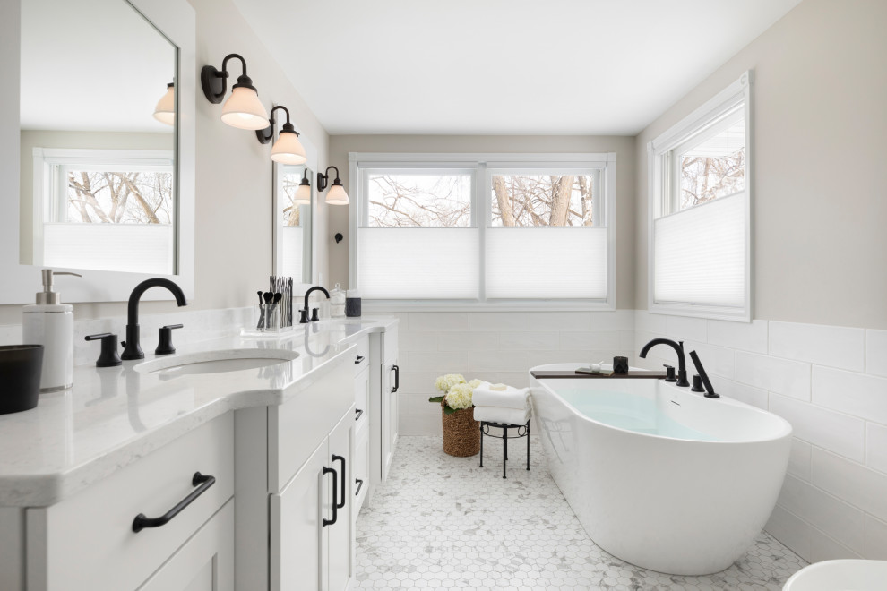Transitional master bathroom in Minneapolis with shaker cabinets, white cabinets, a freestanding tub, grey walls, mosaic tile floors, an undermount sink, multi-coloured floor, white benchtops, a double vanity and a built-in vanity.