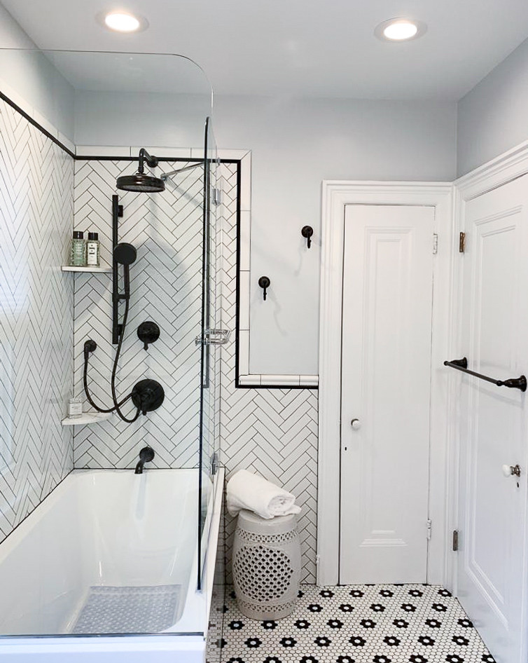 Inspiration for a small modern 3/4 bathroom in Philadelphia with recessed-panel cabinets, dark wood cabinets, a drop-in tub, a corner shower, a two-piece toilet, black and white tile, subway tile, blue walls, mosaic tile floors, an undermount sink, marble benchtops, multi-coloured floor, multi-coloured benchtops and a hinged shower door.