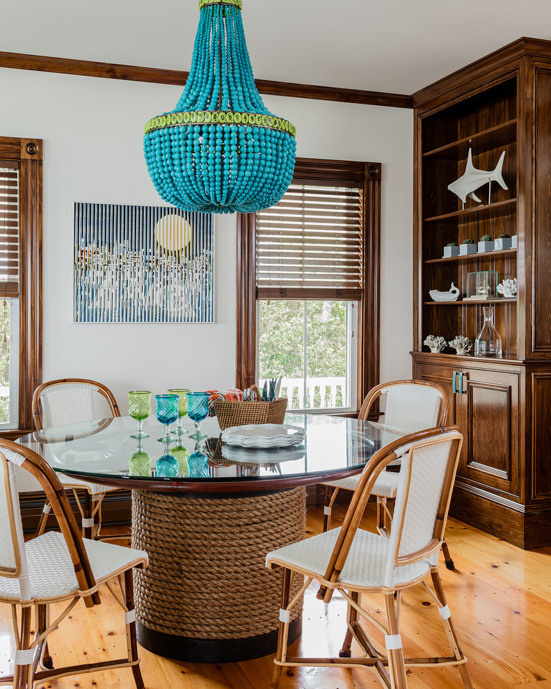 This is an example of a large beach style kitchen/dining combo in Boston with white walls, medium hardwood floors and brown floor.