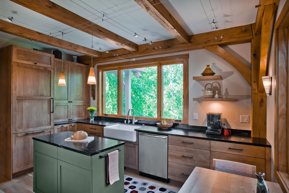 Photo of a mid-sized traditional l-shaped separate kitchen in Minneapolis with a farmhouse sink, shaker cabinets, medium wood cabinets, soapstone benchtops, multi-coloured splashback, slate splashback, panelled appliances, light hardwood floors, with island, brown floor and black benchtop.