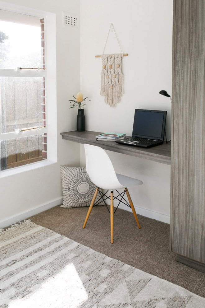 Photo of a contemporary home office in Hobart with white walls, carpet and beige floor.
