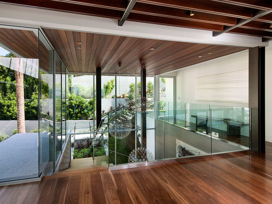 Inspiration for an expansive modern hallway in Los Angeles with white walls and dark hardwood floors.
