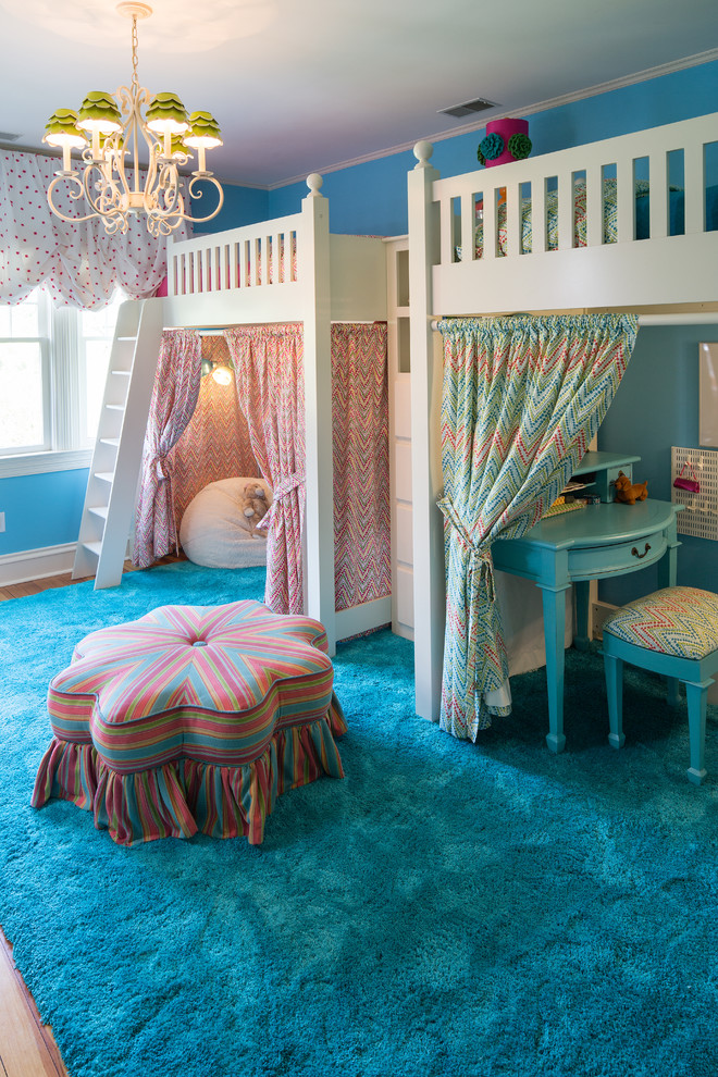 Design ideas for a large traditional kids' bedroom for kids 4-10 years old and girls in Indianapolis with blue walls and medium hardwood floors.