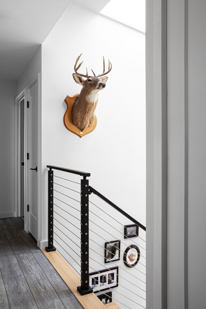 Design ideas for a mid-sized modern hallway in Indianapolis with white walls, vinyl floors and grey floor.