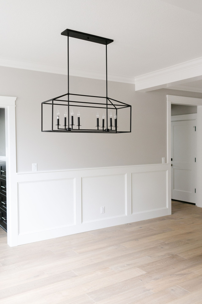 Inspiration for a large arts and crafts open plan dining in Portland with grey walls, light hardwood floors, no fireplace, brown floor and decorative wall panelling.