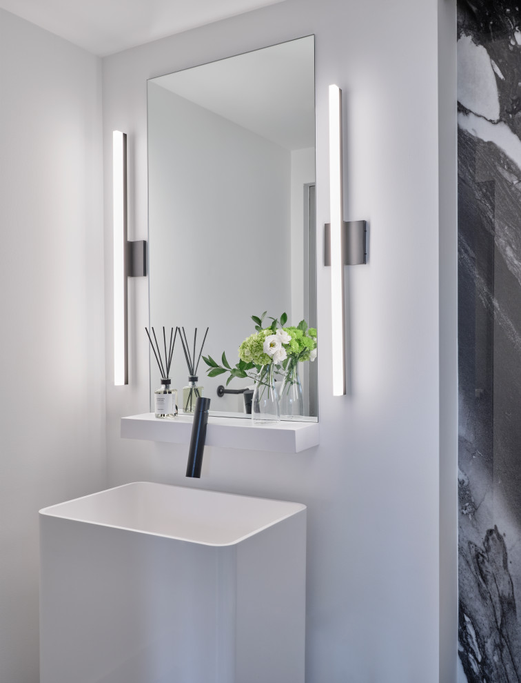 This is an example of a mid-sized contemporary powder room in Toronto with white cabinets, black tile, glass sheet wall, white walls, slate floors, a pedestal sink, black floor and a freestanding vanity.