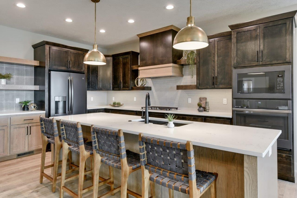 Inspiration for a transitional l-shaped open concept kitchen remodel with shaker cabinets, white backsplash, an island and white countertops