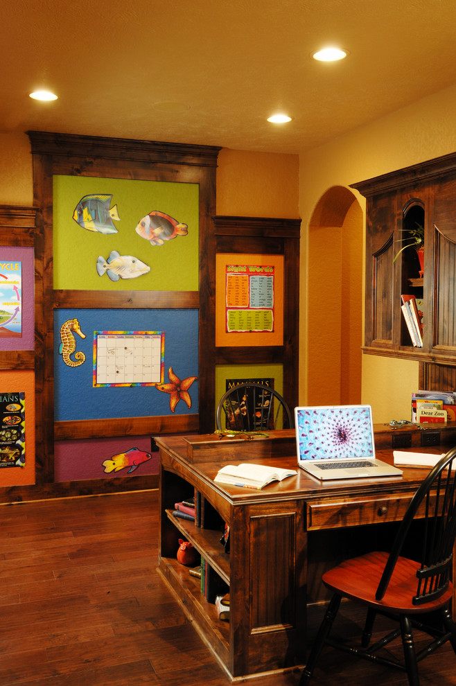 This is an example of a traditional home office in Other with yellow walls.