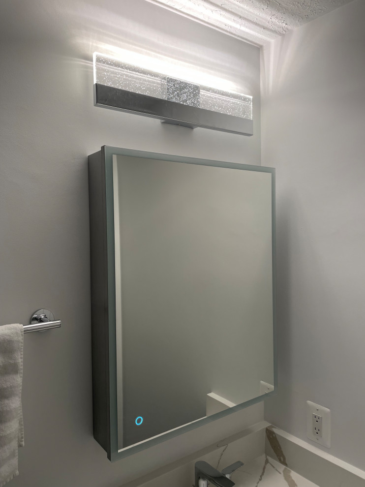 Design ideas for a medium sized modern bathroom in DC Metro with recessed-panel cabinets, grey cabinets, an alcove shower, a two-piece toilet, blue tiles, porcelain tiles, white walls, porcelain flooring, a submerged sink, quartz worktops, grey floors, an open shower, white worktops, a single sink and a built in vanity unit.