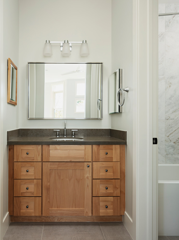 Example of a mid-sized transitional kids' gray tile and marble tile porcelain tile and gray floor doorless shower design in Phoenix with shaker cabinets, beige cabinets, a one-piece toilet, gray walls, an undermount sink, quartz countertops, a hinged shower door and gray countertops