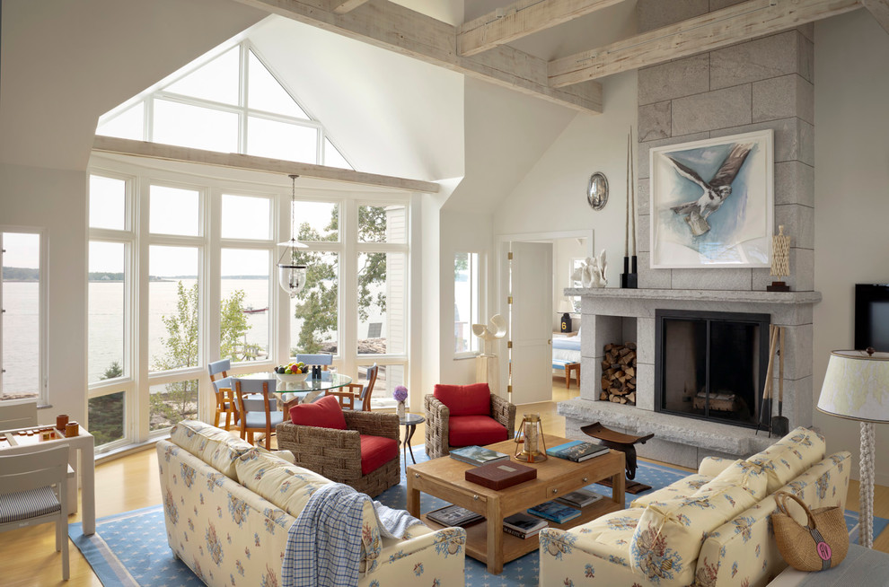 Design ideas for a beach style living room in Portland Maine with white walls, medium hardwood floors and a standard fireplace.