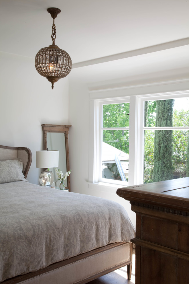 Photo of an arts and crafts master bedroom in San Diego with white walls and medium hardwood floors.