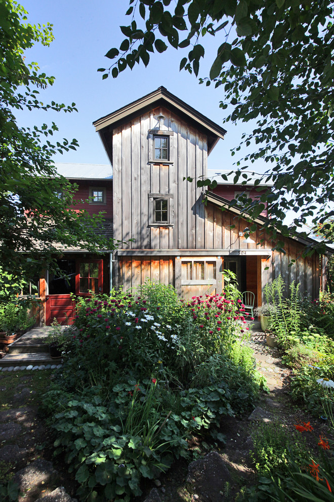This is an example of an eclectic three-storey exterior in Seattle with mixed siding.