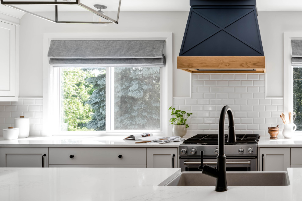 Inspiration for a large transitional l-shaped kitchen remodel in Toronto with shaker cabinets and an island