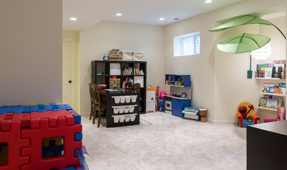 Large transitional gender-neutral kids' playroom in Calgary with beige walls, carpet and beige floor for kids 4-10 years old.