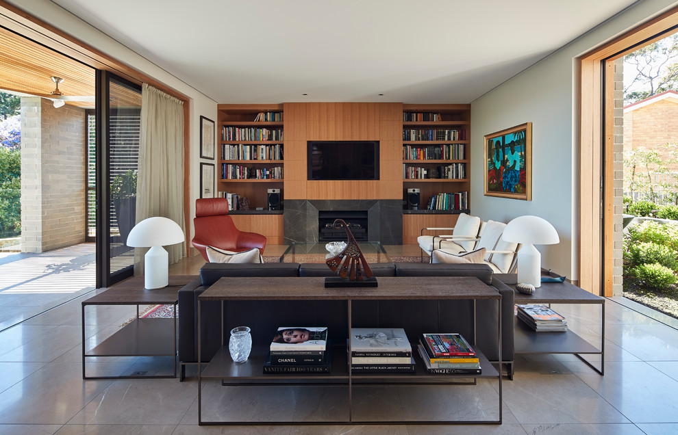 Mid-sized contemporary formal open concept living room in Sydney with white walls, marble floors, a standard fireplace, a stone fireplace surround, a wall-mounted tv and grey floor.