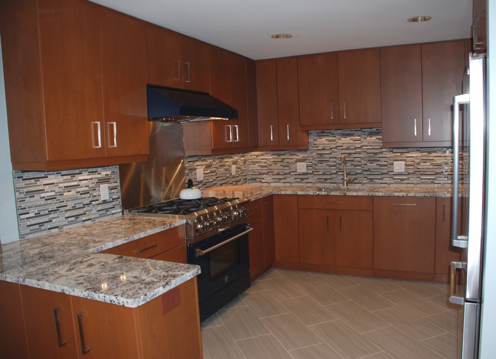 Mid-sized transitional l-shaped eat-in kitchen in DC Metro with an undermount sink, flat-panel cabinets, medium wood cabinets, granite benchtops, multi-coloured splashback, matchstick tile splashback, stainless steel appliances, vinyl floors and a peninsula.
