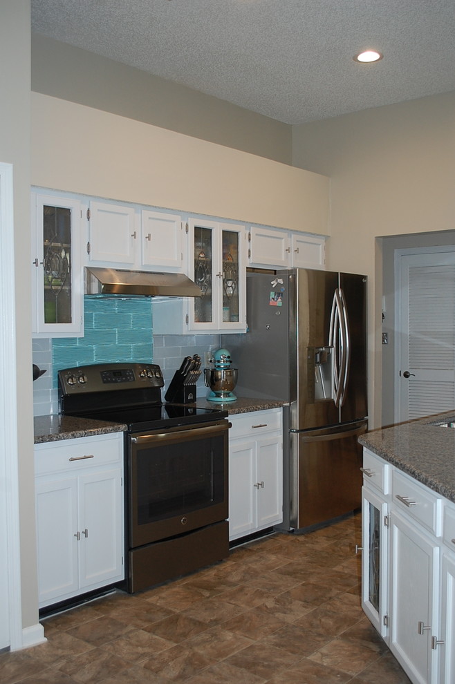 Inspiration for a transitional u-shaped kitchen remodel in Jacksonville with shaker cabinets, white cabinets and granite countertops