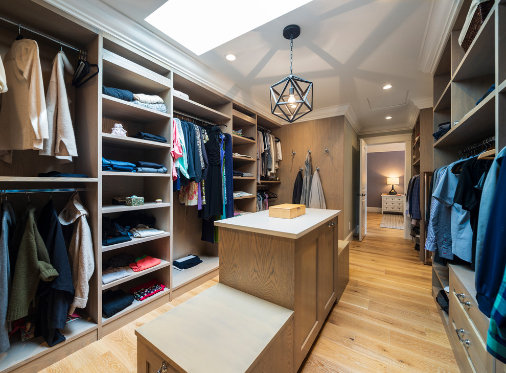 Expansive beach style gender-neutral dressing room in Vancouver with flat-panel cabinets, light wood cabinets, light hardwood floors and beige floor.