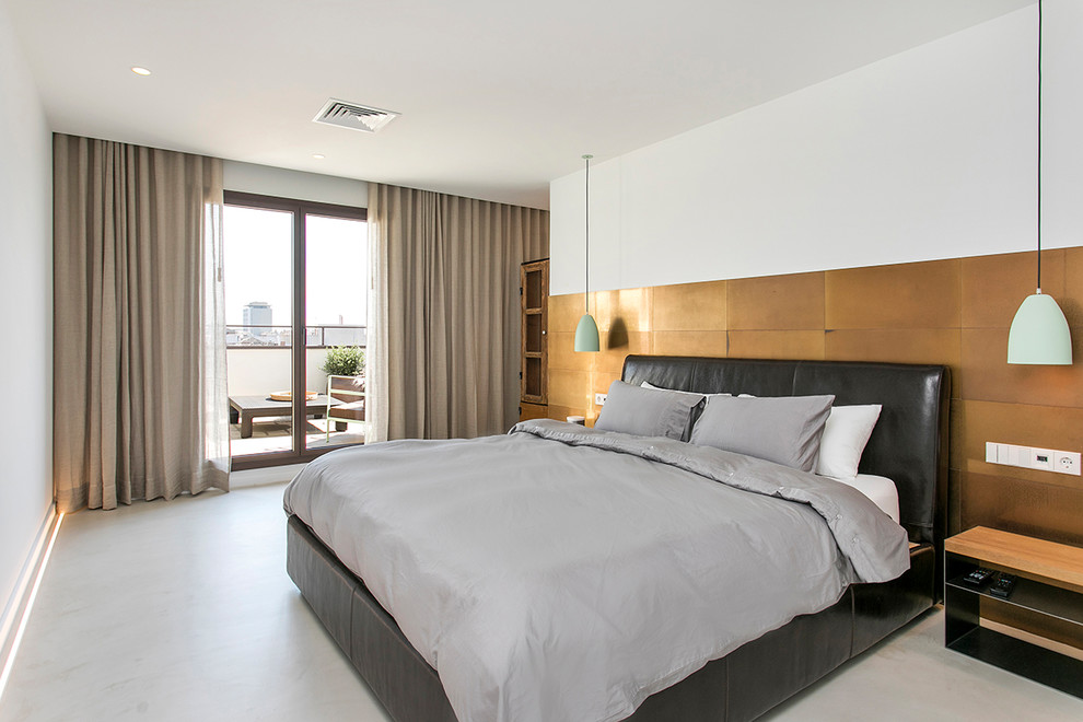Modern master bedroom in Barcelona with white walls and grey floor.