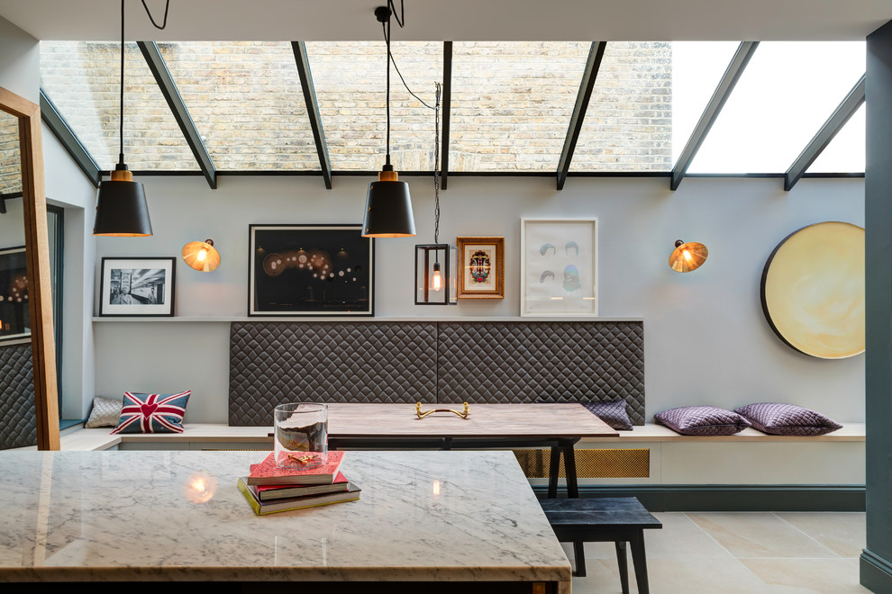 Scandinavian kitchen/dining combo in London with grey walls and beige floor.
