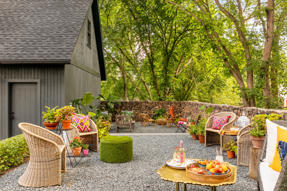 Inspiration for a mid-sized eclectic two-story and side yard stucco and gravel white patio remodel in Minneapolis with a shingle roof and no cover