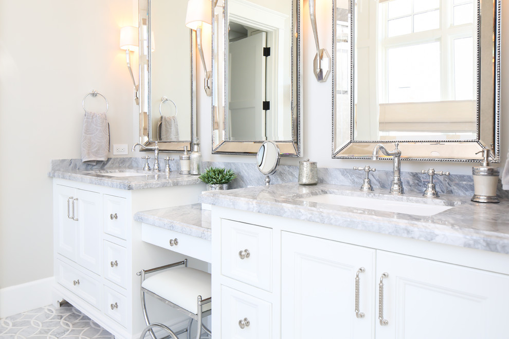 This is an example of a beach style bathroom in Orange County with an undermount sink, recessed-panel cabinets and white cabinets.