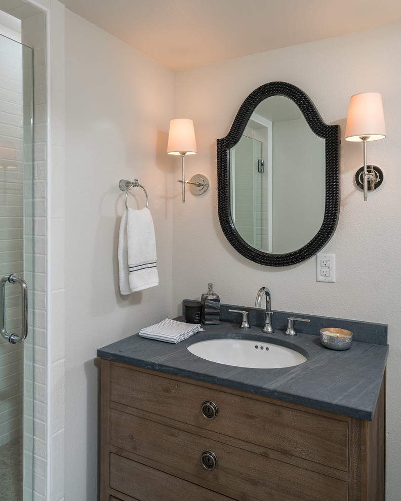 Inspiration for a small transitional 3/4 bathroom in Miami with furniture-like cabinets, medium wood cabinets, an alcove shower, a two-piece toilet, white tile, porcelain tile, white walls, porcelain floors, an undermount sink, soapstone benchtops, grey floor and a hinged shower door.