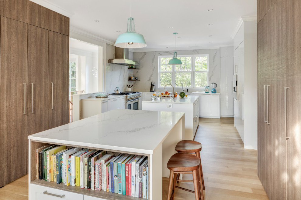 Inspiration for a large beach style l-shaped kitchen pantry in Boston with flat-panel cabinets and multiple islands.