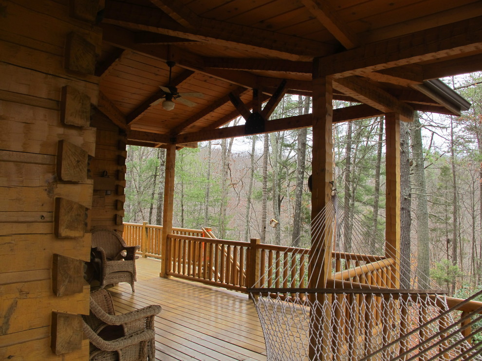 Deck - mid-sized rustic backyard deck idea in Detroit with a roof extension