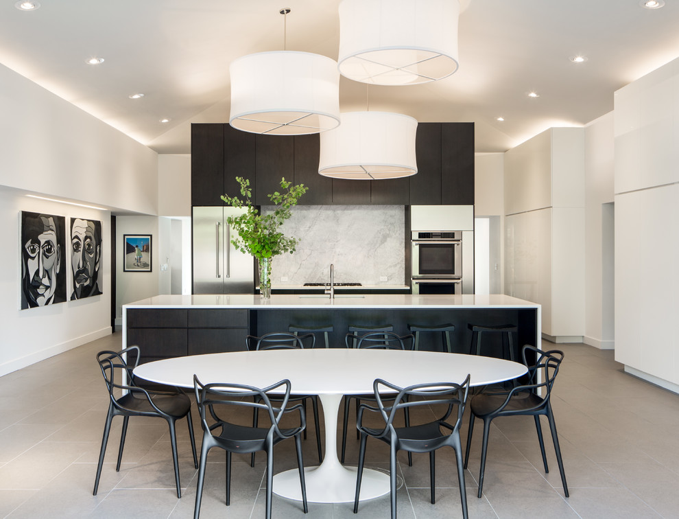 Photo of a contemporary eat-in kitchen in Denver with quartzite benchtops, stone slab splashback, stainless steel appliances, porcelain floors, with island, an undermount sink, flat-panel cabinets and white splashback.