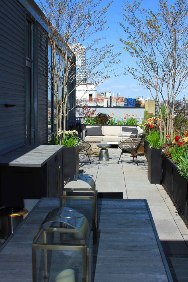 Mid-sized modern rooftop and rooftop deck in New York with a fire feature, no cover and metal railing.
