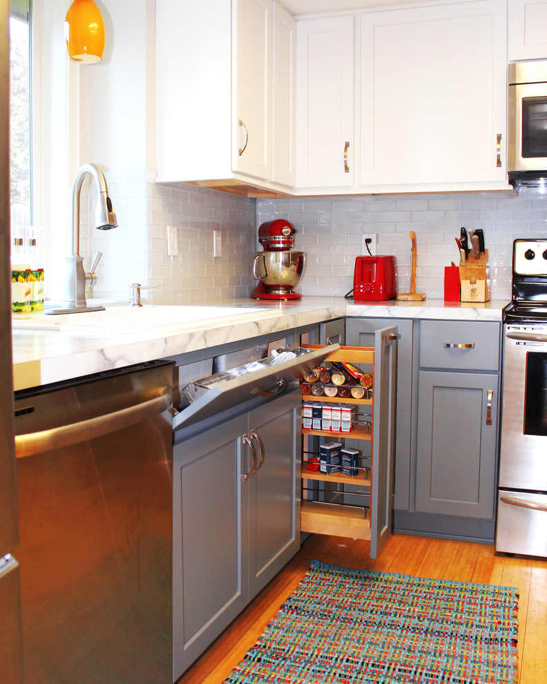Eat-in kitchen - mid-sized transitional u-shaped bamboo floor eat-in kitchen idea in Boise with a drop-in sink, shaker cabinets, gray cabinets, laminate countertops, white backsplash, glass tile backsplash and stainless steel appliances