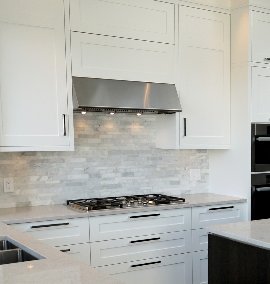 Inspiration for a contemporary l-shaped open plan kitchen in Vancouver with an undermount sink, shaker cabinets, white cabinets, quartz benchtops, grey splashback, stone tile splashback, stainless steel appliances, dark hardwood floors and with island.