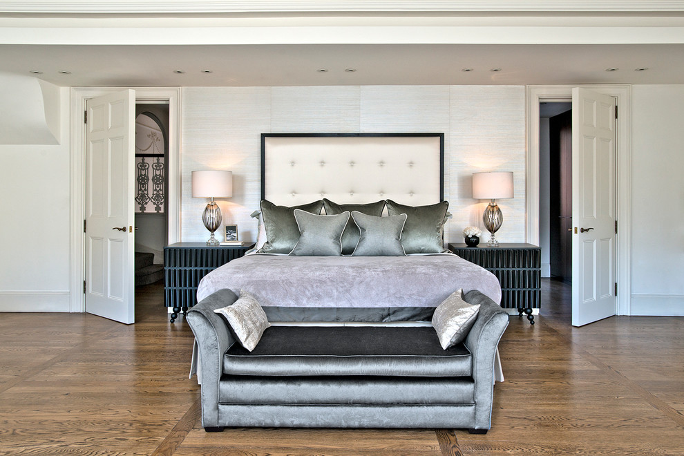This is an example of a contemporary bedroom in London with white walls and dark hardwood floors.