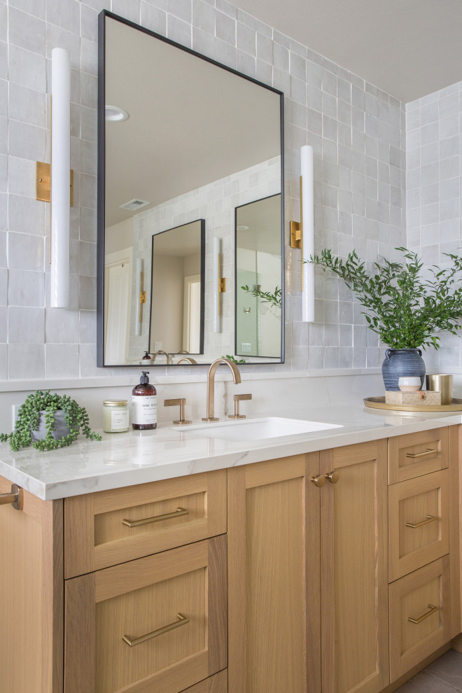 Inspiration for a large transitional master gray tile and terra-cotta tile porcelain tile, gray floor and double-sink freestanding bathtub remodel in Seattle with shaker cabinets, light wood cabinets, a one-piece toilet, white walls, an undermount sink, quartz countertops, a hinged shower door, white countertops and a built-in vanity