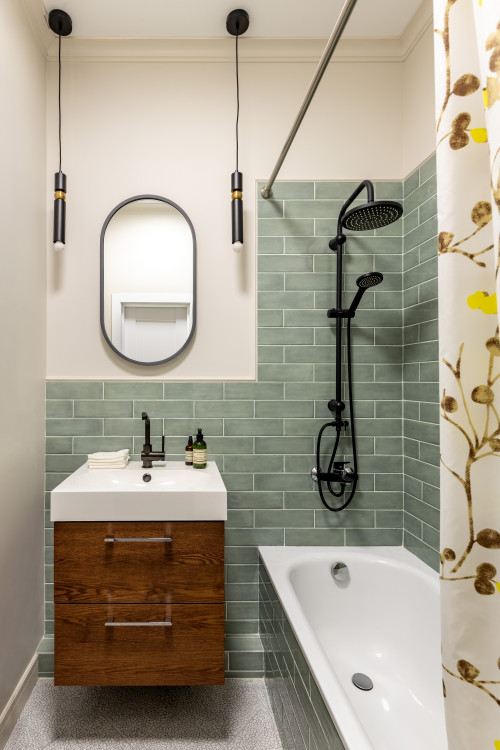 Cozy Elegance: Small Vanity, Black Hardware, and Green Subway Tile