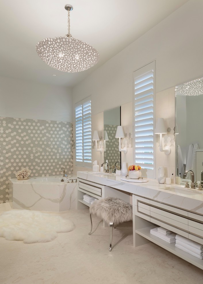 Photo of a large contemporary master bathroom in Miami with flat-panel cabinets, white cabinets, a corner tub, multi-coloured tile, glass tile, an undermount sink, marble benchtops, white walls and white floor.