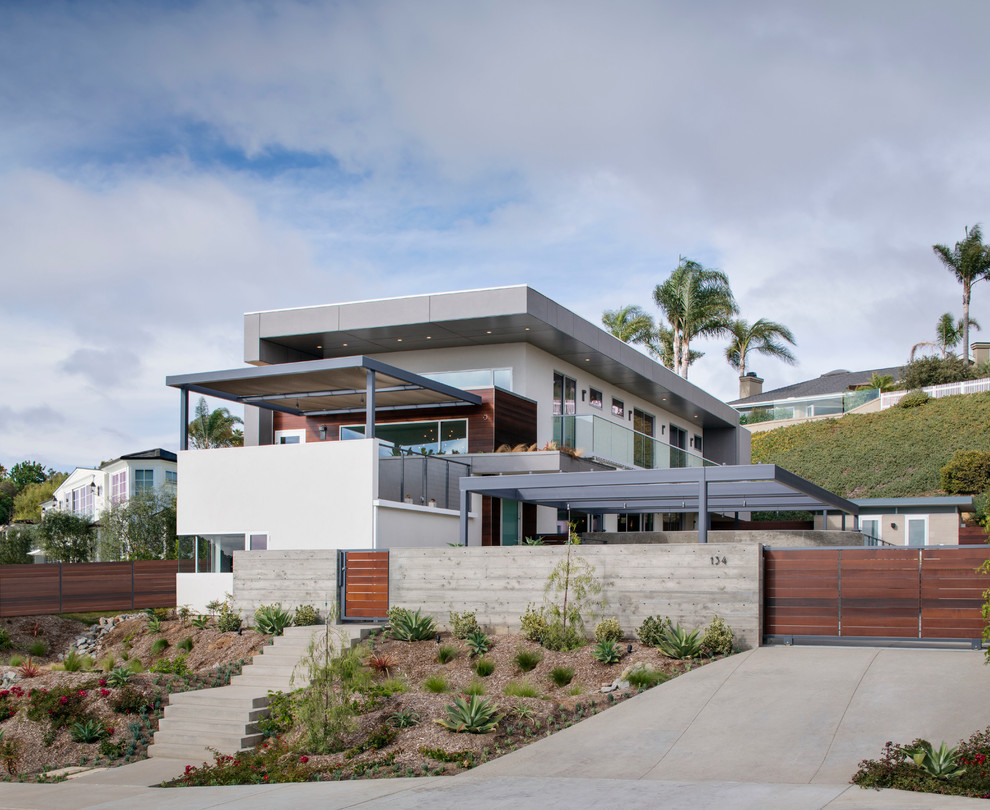 Inspiration for a large beach style split-level exterior in San Diego with a flat roof.