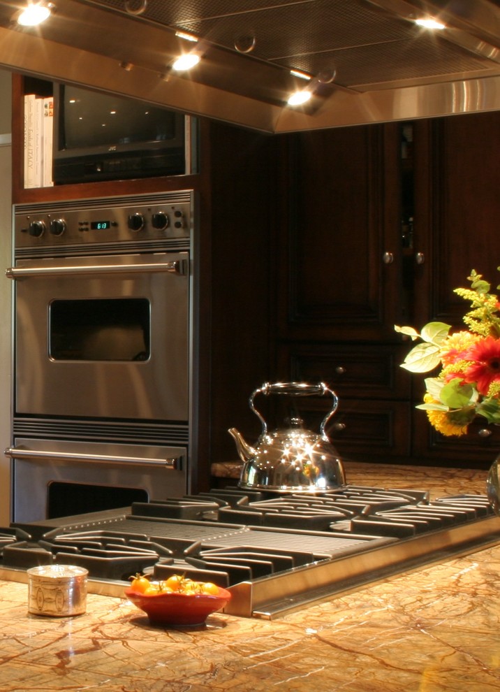 Example of a large transitional u-shaped terra-cotta tile open concept kitchen design with a farmhouse sink, furniture-like cabinets, dark wood cabinets, granite countertops, stone slab backsplash, stainless steel appliances, white walls and an island